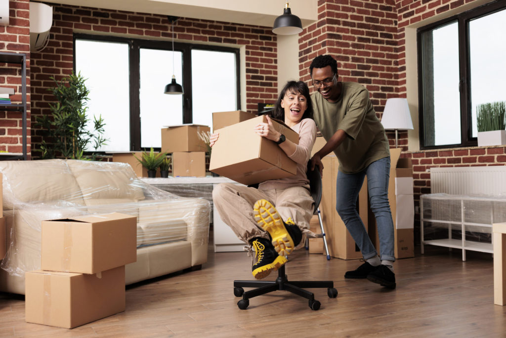 Cheerful homeowners enjoying moving in new rented household